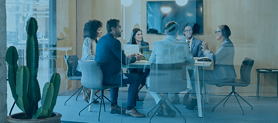 Group of people sitting around a conference table